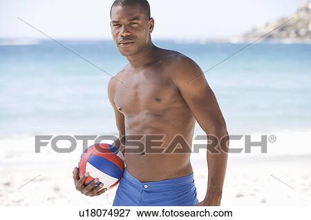 A man holding a ball View Large Photo Image Stock Photo - A man holding a ball. Fotosearch