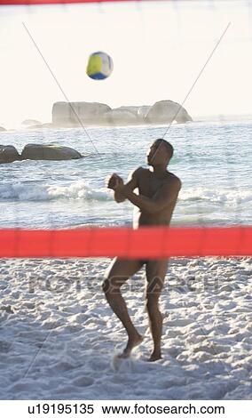 Stock Photography - A man playing beach volleyball. Fotosearch