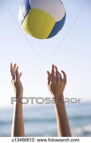 Stock Image - A woman catching a ball. Fotosearch