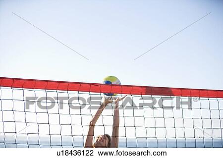 A woman playing beach volleyball View Large Photo Image Stock Image - A woman playing beach volleyball. Fotosearch