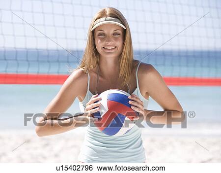 A woman playing beach volleyball View Large Photo Image Stock Photograph - A woman playing beach volleyball. Fotosearch