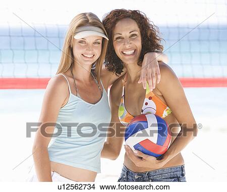 Picture - Two women playing beach volleyball. Fotosearch