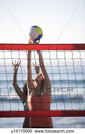 Two women playing beach volleyball View Large Photo Image Stock Image - Two women playing beach volleyball. Fotosearch