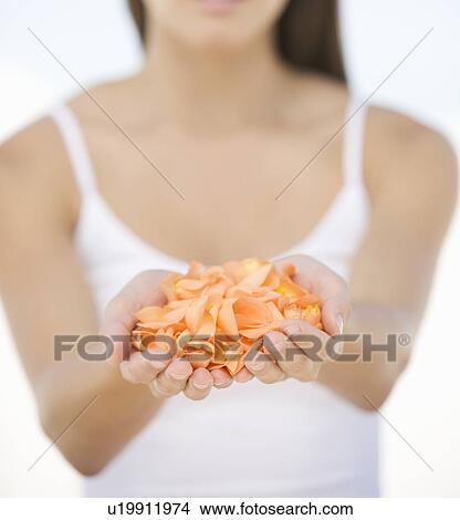 Picture - A woman with a handful of petals. Fotosearch