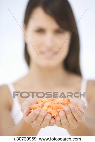 A woman with a handful of petals View Large Photo Image Stock Photo - A woman with a handful of petals. Fotosearch