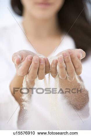 A woman with sand running through her hands View Large Photo Image Stock Image - A woman with sand running through her hands. Fotosearch