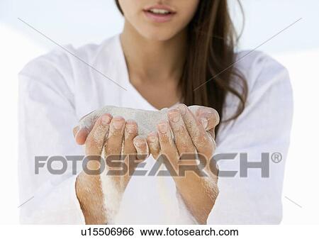 A woman with sand running through her hands View Large Photo Image Stock Photograph - A woman with sand running through her hands. Fotosearch