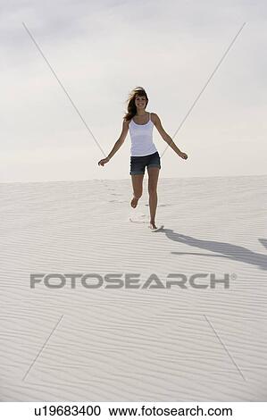 A young woman running in the desert View Large Photo Image Stock Image - A young woman running in the desert. Fotosearch
