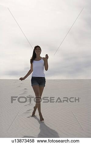 A young woman running in the desert View Large Photo Image Stock Photo - A young woman running in the desert. Fotosearch