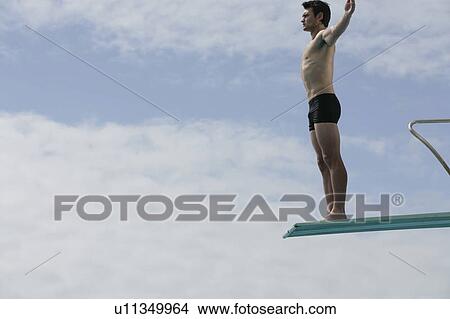 A diver standing on a diving board View Large Photo Image Picture - A diver standing on a diving board. Fotosearch