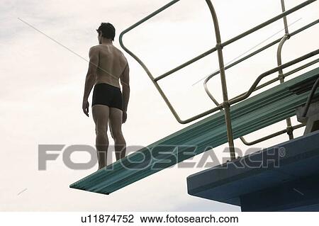 A diver standing on a diving board View Large Photo Image Stock Image - A diver standing on a diving board. Fotosearch