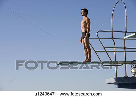 A diver standing on a diving board View Large Photo Image Stock Image - A diver standing on a diving board. Fotosearch
