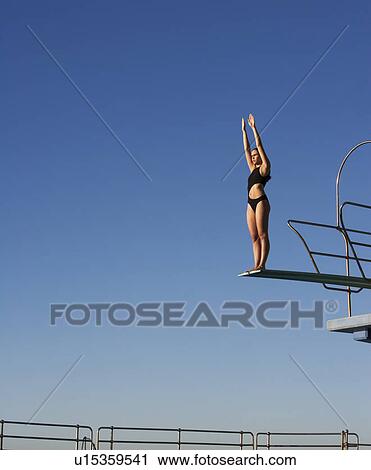 A diver standing on a diving board View Large Photo Image Stock Image - A diver standing on a diving board. Fotosearch