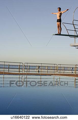 A diver standing on a diving board View Large Photo Image Stock Image - A diver standing on a diving board. Fotosearch