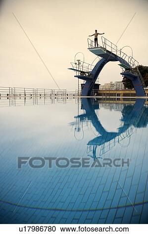 A diver standing on a diving board View Large Photo Image Stock Image - A diver standing on a diving board. Fotosearch
