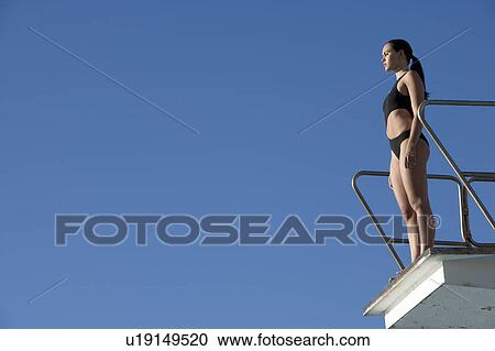 A diver standing on a diving board View Large Photo Image Stock Image - A diver standing on a diving board. Fotosearch