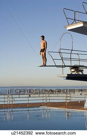 A diver standing on a diving board View Large Photo Image Stock Image - A diver standing on a diving board. Fotosearch