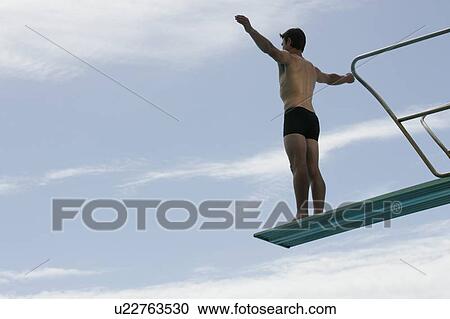 A diver standing on a diving board View Large Photo Image Stock Image - A diver standing on a diving board. Fotosearch