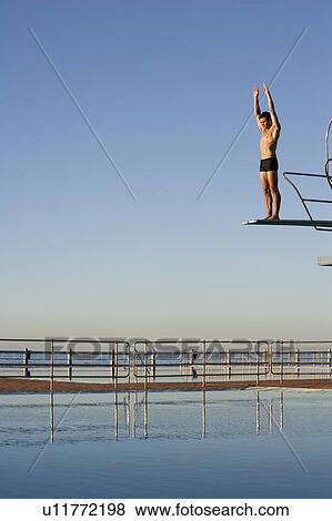 A diver standing on a diving board View Large Photo Image Stock Photo - A diver standing on a diving board. Fotosearch