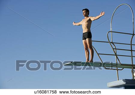 Stock Photo - A diver standing on a diving board. Fotosearch