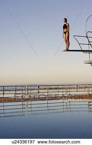 A diver standing on a diving board View Large Photo Image Stock Photo - A diver standing on a diving board. Fotosearch
