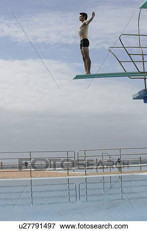 A diver standing on a diving board View Large Photo Image Stock Photo - A diver standing on a diving board. Fotosearch
