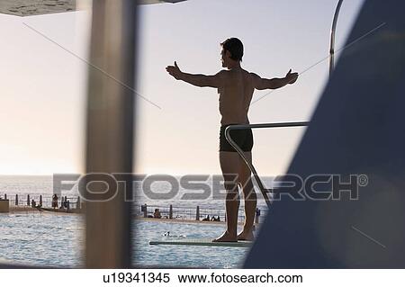 A diver standing on a diving board View Large Photo Image Stock Photography - A diver standing on a diving board. Fotosearch