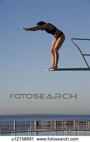 A woman diving into a pool View Large Photo Image Stock Image - A woman diving into a pool. Fotosearch