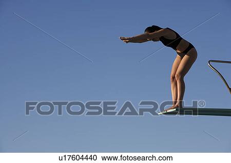 A woman diving into a pool View Large Photo Image Stock Image - A woman diving into a pool. Fotosearch