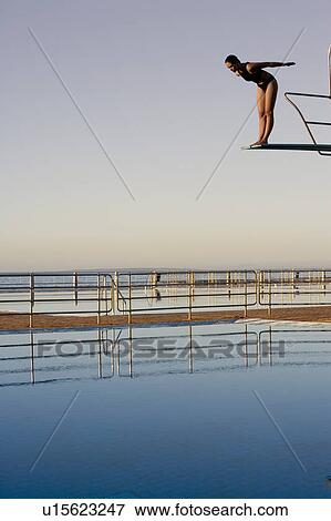 Stock Photo - A woman diving into a pool. Fotosearch
