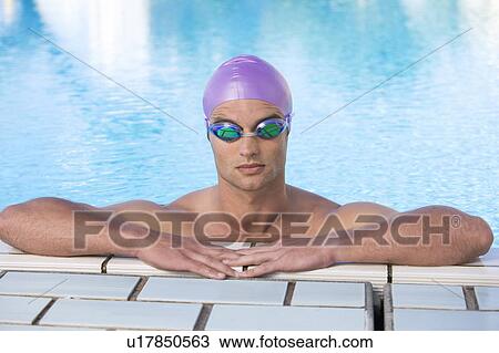 Stock Image - A young man in a swimming pool. Fotosearch