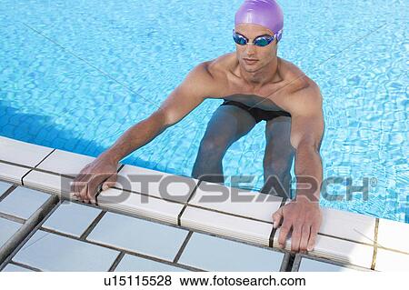 Stock Photo - A young man in a swimming pool. Fotosearch