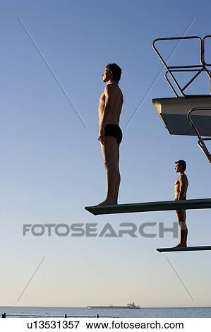 Stock Photo - Two divers standing on diving boards. Fotosearch