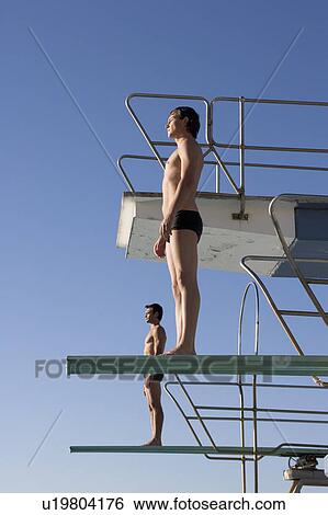 Stock Photograph - Two divers standing on diving boards. Fotosearch