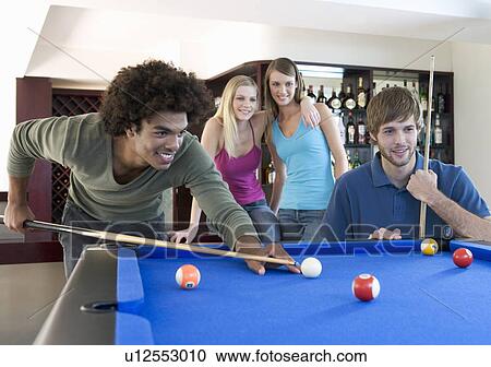 A group of teenage friends playing pool in a bar View Large Photo Image Stock Image - A group of teenage friends playing pool in a bar. Fotosearch