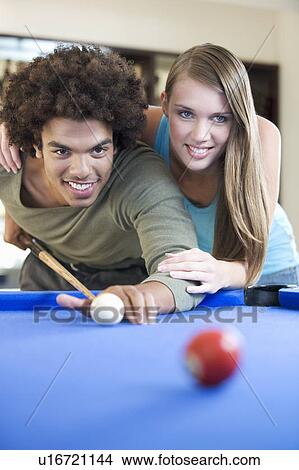A teenage couple playing pool View Large Photo Image Picture - A teenage couple playing pool. Fotosearch
