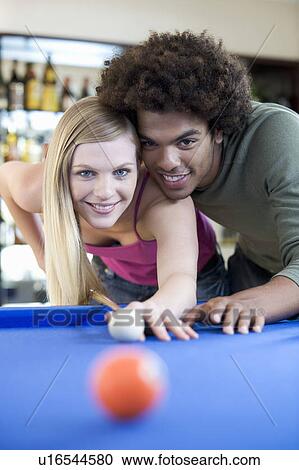 A teenage couple playing pool View Large Photo Image Stock Image - A teenage couple playing pool. Fotosearch