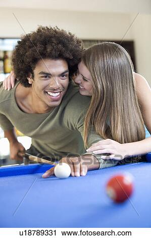 A teenage couple playing pool View Large Photo Image Stock Image - A teenage couple playing pool. Fotosearch