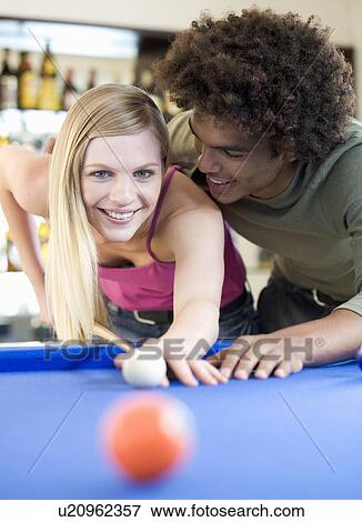A teenage couple playing pool View Large Photo Image Stock Photo - A teenage couple playing pool. Fotosearch