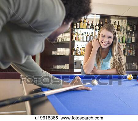A teenage couple playing pool View Large Photo Image Stock Photography - A teenage couple playing pool. Fotosearch
