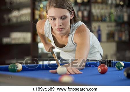 A teenage girl playing pool View Large Photo Image Stock Photo - A teenage girl playing pool. Fotosearch