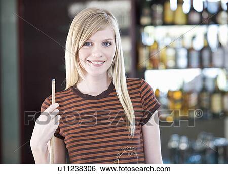 Stock Photograph - A teenage girl playing pool. Fotosearch