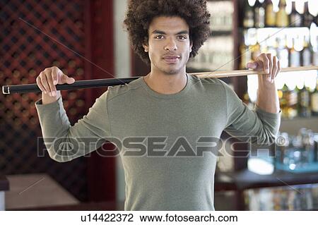 A young man playing pool View Large Photo Image Stock Image - A young man playing pool. Fotosearch