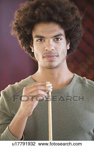 A young man playing pool View Large Photo Image Stock Image - A young man playing pool. Fotosearch