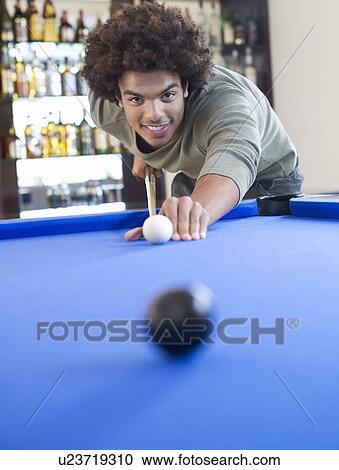 A young man playing pool View Large Photo Image Stock Image - A young man playing pool. Fotosearch