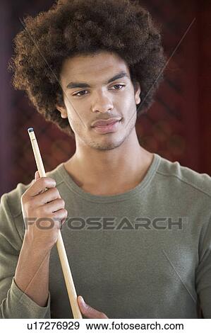 A young man playing pool View Large Photo Image Stock Photo - A young man playing pool. Fotosearch
