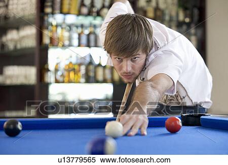 A young man playing pool View Large Photo Image Stock Photography - A young man playing pool. Fotosearch