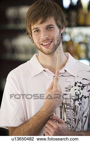 Portrait of a young man playing pool View Large Photo Image Stock Image - Portrait of a young man playing pool. Fotosearch