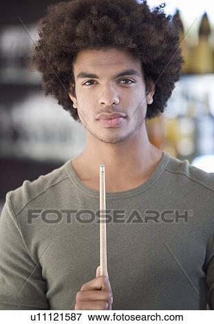 Portrait of a young man playing pool View Large Photo Image Stock Photo - Portrait of a young man playing pool. Fotosearch