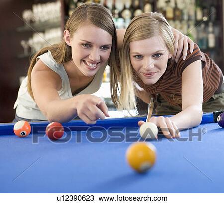 Two teenage girls playing pool View Large Photo Image Stock Image - Two teenage girls playing pool. Fotosearch